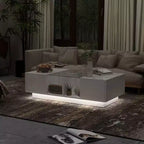 Table basse à LED blanc laqué avec rangements multi-zones, tiroir et compartiments ouverts